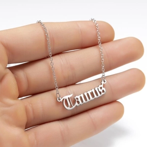 Macro shot of silver Taurus zodiac necklace pendant with elegant script lettering
