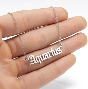 Close-up of gothic Aquarius letter pendant necklace on a delicate silver chain