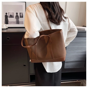 Macro shot of deep brown lychee texture leather shoulder bag with fine stitching detail