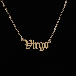 Detailed macro view of the gold Virgo zodiac pendant with a gothic font design