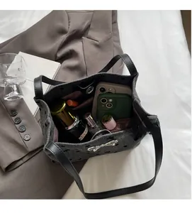 Interior view of grey felt tote bag showing spacious capacity for phone and cosmetics