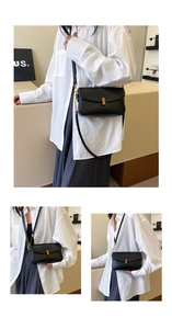 Detail of a black matte crossbody bag featuring a classic gold rectangular metal buckle lock