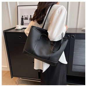 Close-up of black lychee grain tote bag with dual straps for versatile shoulder carry