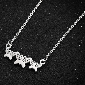 Macro shot of silver jigsaw butterfly pendant with intricate hollowed-out metal detailing