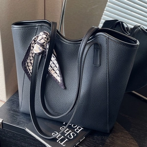 Black lychee textured tote bag with decorative geometric silk scarf for daily office use