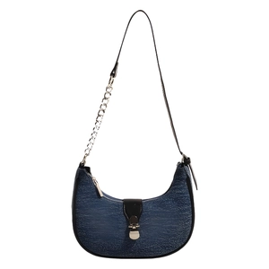 Blue textured crescent baguette bag with silver chain strap and metal lock closure