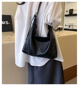 Detail of black lychee grain leather hobo bag showing large capacity and soft texture