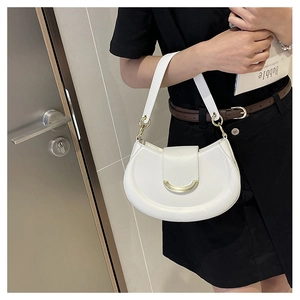 Detail of white crescent shoulder bag with gold hardware and smooth leather texture