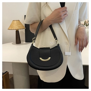 Detail of a black matte crescent bag with a gold metal buckle and leather strap