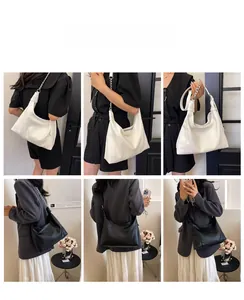 Detail view of large hobo bags with silver chain straps in black and white leather