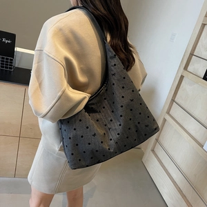 Grey canvas polka dot tote bag with black bow print and wide shoulder strap