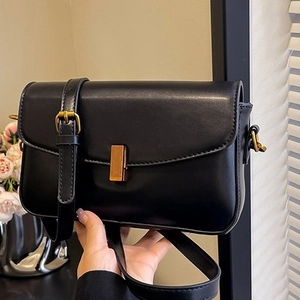 Retro black leather crossbody bag with vintage gold buckle and adjustable shoulder strap