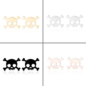 Detailed view of skull and crossbones stud earrings in gold, silver, black, and rose gold