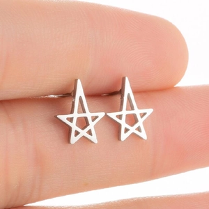 Detailed macro view of minimalist hollow star-shaped stainless steel stud earrings