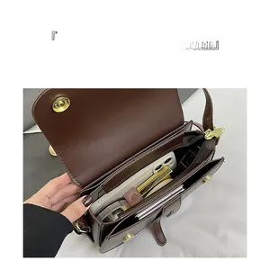 Interior view showing the large capacity and compartments of the brown saddle bag