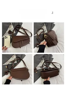 Detail view of a dark brown matte leather saddle bag from front, side, back, and bottom