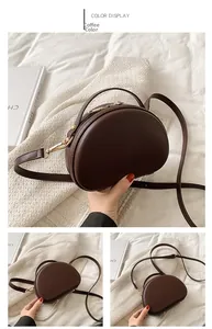 Dettaglio della borsa vintage marrone con cerniera dorata e pelle liscia di alta qualità