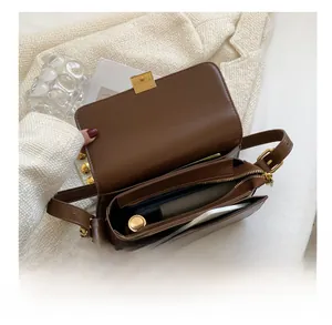 Interior view of brown leather crossbody bag showing card slots and storage capacity