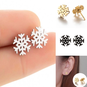 Detail shot of snowflake stud earrings in silver, gold, and black with polished finish