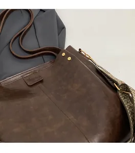 Detail view of vintage brown tote bag with textured faux leather and dual shoulder straps