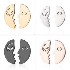 Macro detail of split-face moon earrings in gold, silver, black and rose gold finishes