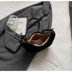 Detail view of the black matte hobo bag's interior lining with a secure zipper pocket