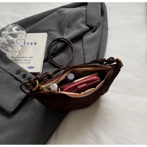 Detailed interior of dark brown crescent bag showing spacious storage for essentials