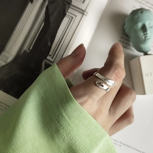 Crossed silver faith ring with cross detail and adjustable open band on finger