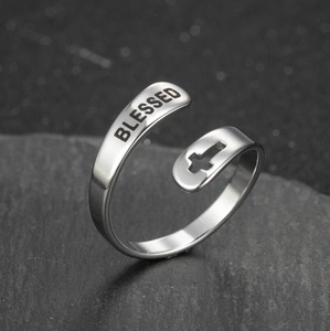 Macro shot of silver adjustable ring featuring blessed engraving and cross cutout detail