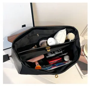 Top-down view of spacious black tote bag interior showing organized compartments and items