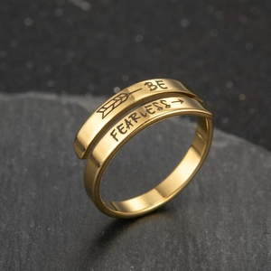 Adjustable gold stainless steel ring engraved with 'BE FEARLESS' on stone surface