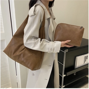 Detail of vintage brown leather tote bag with matching inner pouch for urban commute