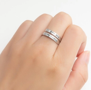 Detailed shot of silver adjustable ring featuring you are my sunshine engraving