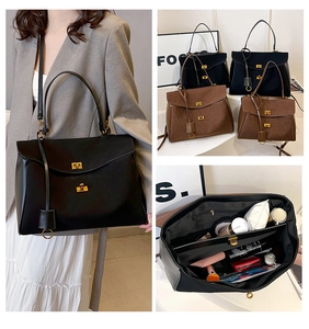 Detail of the minimalist tote bag showing the gold metal twist lock and spacious interior