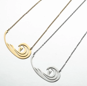 Detail of bird-shaped necklace pendants in gold and silver finish with cross chains