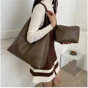 Detail of dark olive brown soft leather tote bag set with matching inner clutch pouch