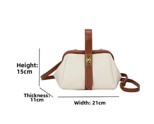 Detail view of a shell-shaped crossbody bag with dimensions 21x15x11cm and metal lock