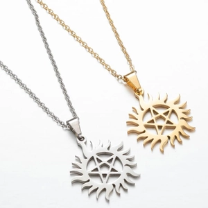 Detailed view of gold and silver sunburst pendants with star motifs on steel chains