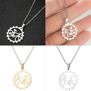 Detailed views of gold and silver bicycle gear pendant necklaces on various backgrounds