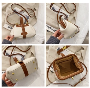Detail view of cream pebble leather doctor bag with gold hardware and bottom metal studs