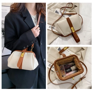 Detail view of cream shell bag showing interior capacity and stylish handle design