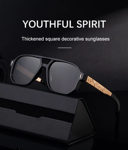 Detail of square black sunglasses featuring gold metal temples with star pattern relief