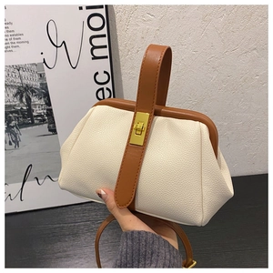 Detail of vintage cream doctor bag with lychee texture leather and gold twist lock