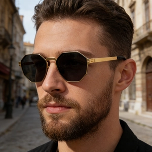 Close-up of men's square polarized sunglasses with vintage gold metal frame in a street setting