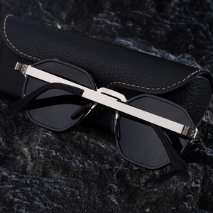 Close-up of polarized polygon sunglasses with silver metal frame and black leather case