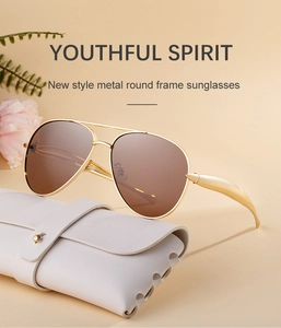 Detail of aviator metal sunglasses with brown lenses and premium white leather case