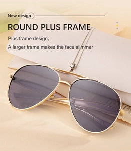 Close-up of golden aviator sunglasses with tinted lenses and beige leather pouch
