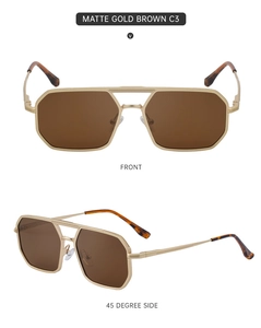 Détail de lunettes de soleil pilote dorées mates avec monture géométrique et verres marron