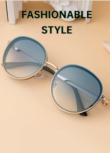 Detailed macro shot of vintage round gold metal sunglass frame and gradient blue lenses