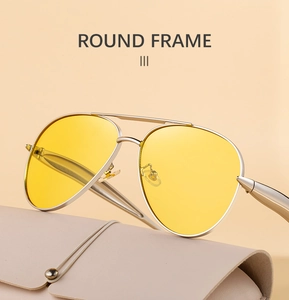 Close-up of pilot sunglasses with yellow lenses and silver metal frame with leather pouch